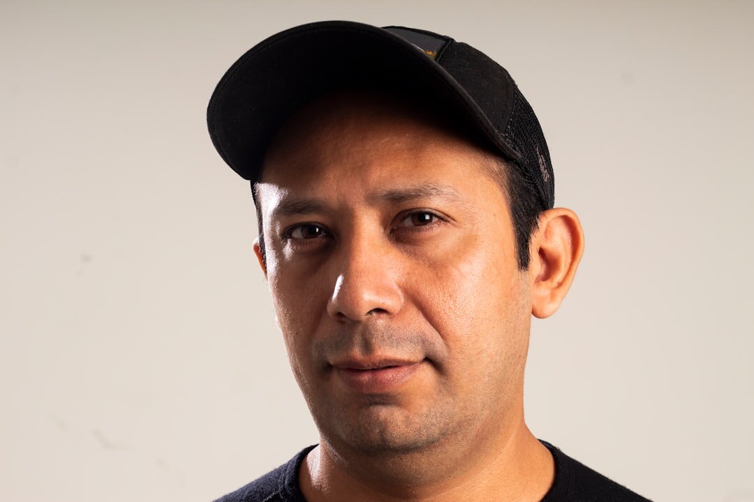 Studio portrait of a Latin American man editor with a friendly expression